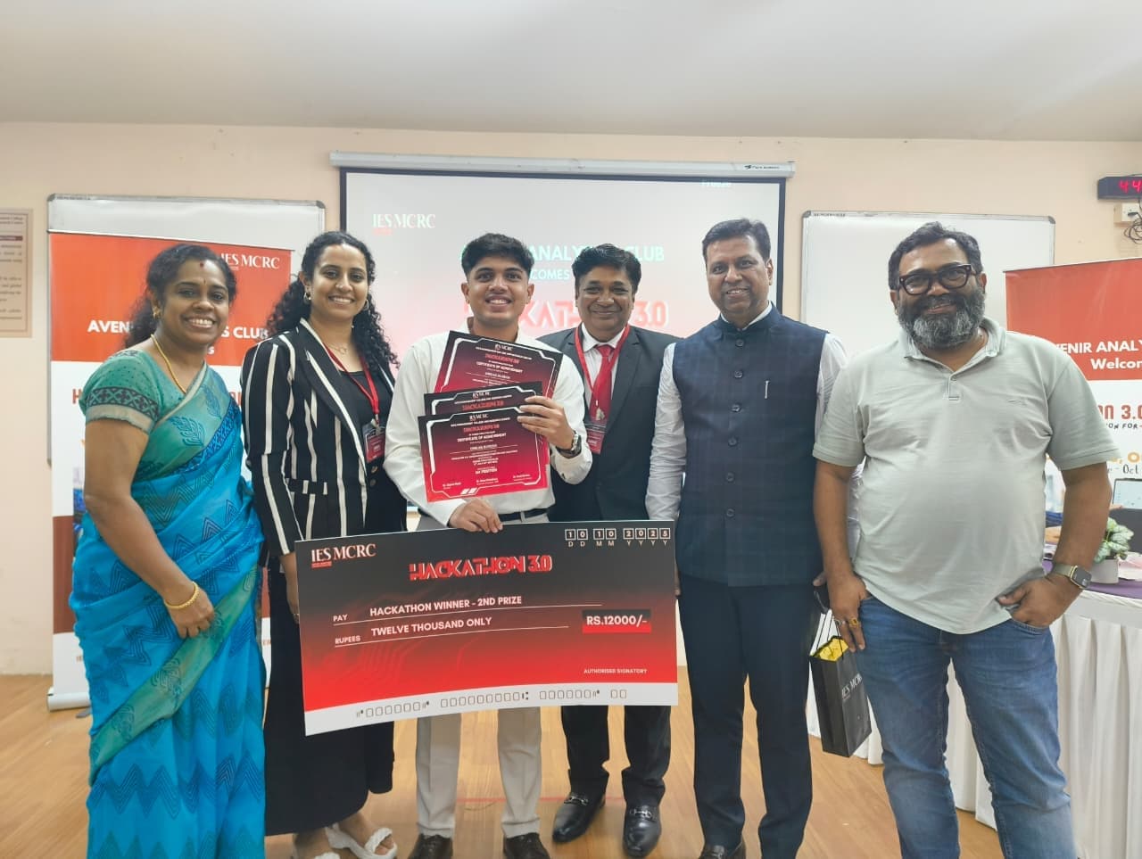Team holding three awards at IES Business School